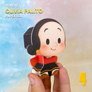 Vista lateral do Papertoy Olívia Palito mostrando os detalhes do vestido e acabamento artesanal